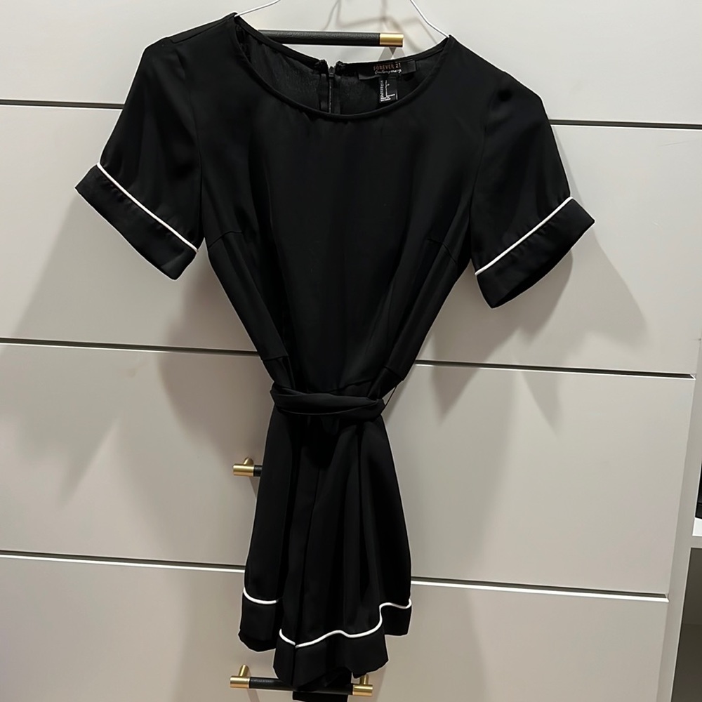 Sheer black romper with white trim detail